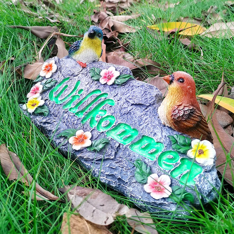 Garden resin welcomes colorful bird ornaments