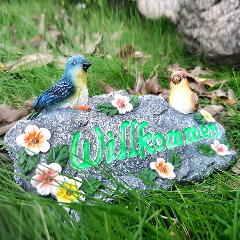 Garden resin welcomes colorful bird ornaments